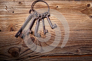 Rusty medieval keys on wood table