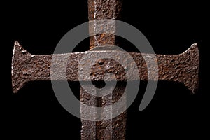 Rusty medieval sword on black background