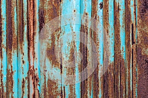 Rusty metal background with old layers of blue paint. Texture ru