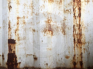 Rusty metal background with old layers of white paint. Texture rusted shipping container.