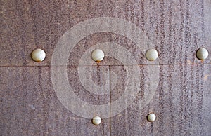 Rusty metal background with rivets for design