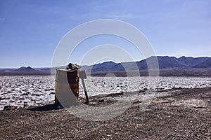Rusty Metal Barrel and Wooden Sing in the Atacama Desert