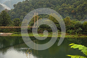 Rusty metal bridge over river in mountains