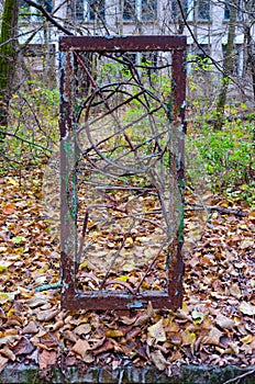 Rusty metal construction depicting globe near school in dead abandoned ghost town of Pripyat in Chernobyl alienation zone photo