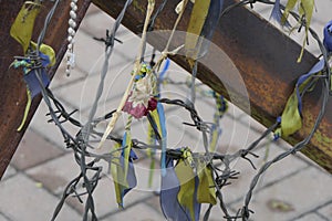 On rusty metal crossbars installed crosswise - ribbons.