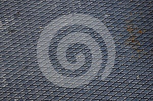 Rusty metal floor, covering. Diamond-shaped rusty metallic coating,