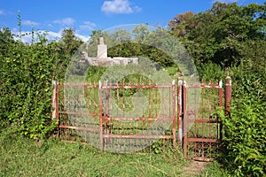 Rusty metal gate of abandoned yard