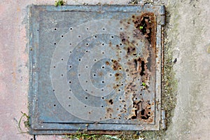 Rusty metal manhole cover on floor