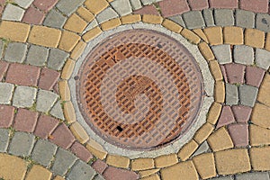 Rusty metal manhole cover in a street