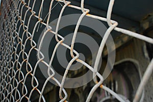 Rusty metal mesh close-up on the background of painted walls