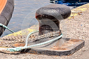 Rusty metal mooring bolard for big ship