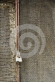 Rusty metal net and rusty padlock 15