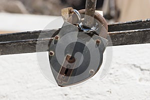 Rusty metal padlock on the railing