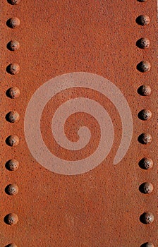 Rusty metal plate with rivets