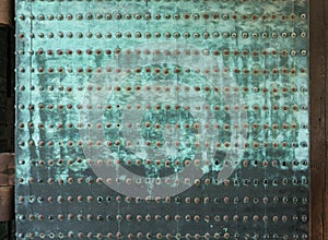 Rusty metal riveted plates on doors in Nijo Castle in Kyoto.