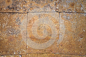 Rusty metal surface with rivets