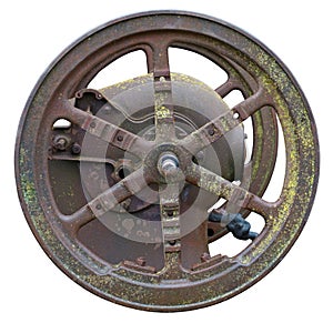 Rusty metal vintage wheel from an retro  agricultural  motor  and machinery with moss  spots isolated