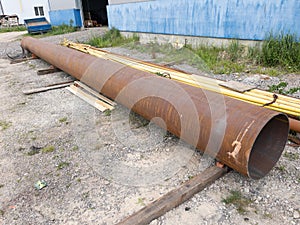 Rusty metal welded pipe near the warehouse