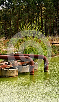 Rusty metall pipes ending in the water.