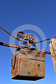 Rusty mining bucket on aerial tram