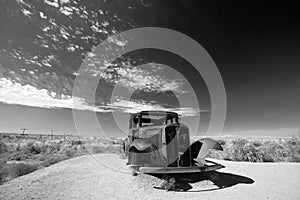 Rusty Model T in black and white on Route 66 in the Painted Desert National Park in Arizona United States