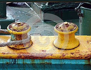 Rusty Mooring Post with a Thick Rope