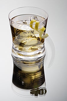 Rusty nail cocktail with lemon peel