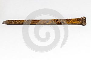 Rusty nail covered with a brown oxidant on a white background photo