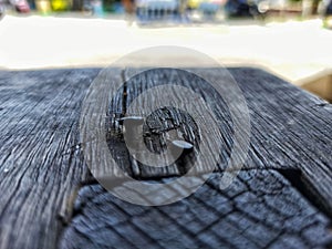 Rusty Nail Lodged in Weathered Bench