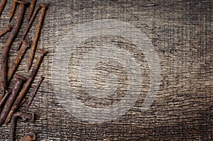 Rusty nails in the background of the old wooden