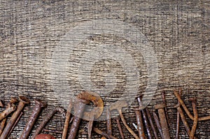 Rusty nails on old wood background