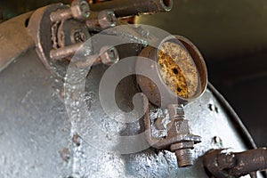 Nanometers on boiler inside old, steam locomotion photo