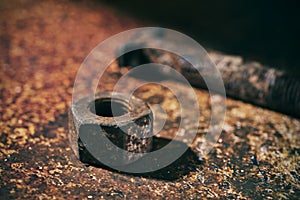 Rusty nut and bolt on a rusty surface