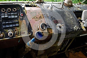 Rusty, old abandoned bus cab with front panel and blue gearbox shifter