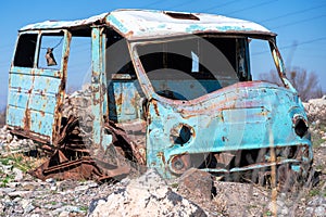 Rusty, old and abandoned Soviet Russian van out in the wasteland