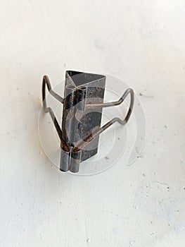 Rusty old binder clip in black color closeup shot