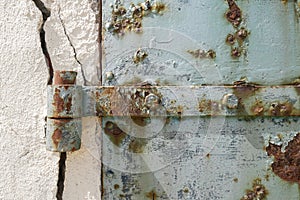 Rusty old blue door with cracked wall, abstract and textured background