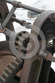 Rusty old boat winch on the dock