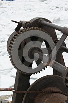 Rusty old boat winch on the dock