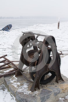 Rusty old boat winch on the dock