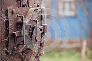 Rusty old door lock mechanism with crackled, scratch, covered with spiders net