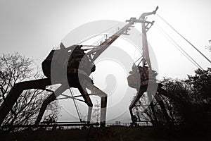 Rusty old industrial dock cranes at the Dock