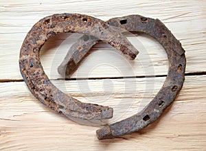 Rusty old iron horseshoes as a love heart sign
