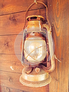 Rusty Old Lantern On Wooden Wall