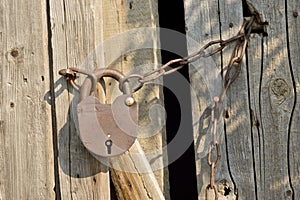 Rusty old lock on a wooden door