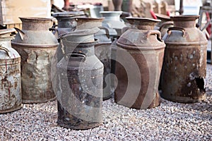 Rusty old milk cans at a flea market