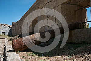 Rusty old Napoleonic cannon lies in an old stone fortress in Porto, Portugal