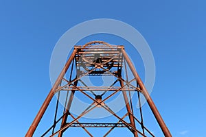 Rusty old poppet head structure left over from the gold mining