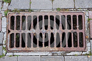 Rusty old rectangular sewer grate