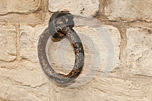 Rusty old ring at a brickwork wall